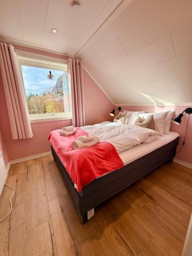 a bedroom with a large bed with a window at KB - Nordic Lux Villa in Sørvågen