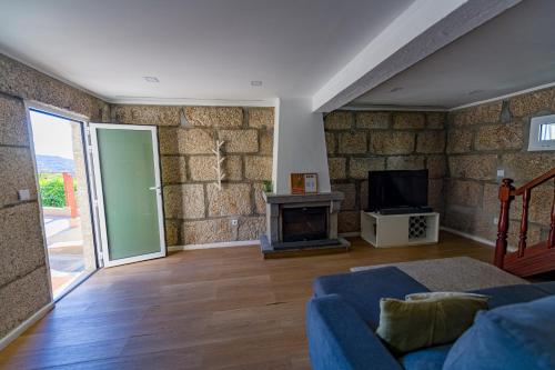 a living room with a couch and a fireplace at Casa da Boavista in Amarante