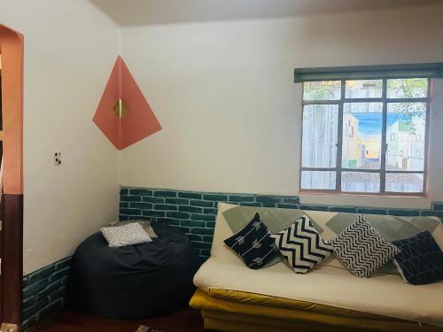 a living room with a couch with pillows on it at La Casita in Mexico City