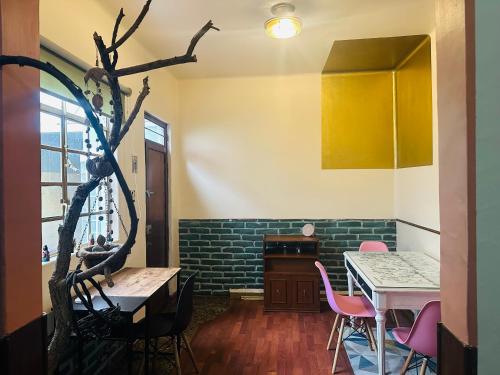 a dining room with a table and pink chairs at La Casita in Mexico City