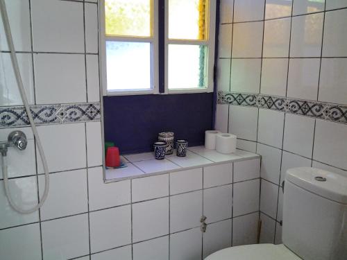 a bathroom with a toilet and a window at Dar Gentille in Essaouira
