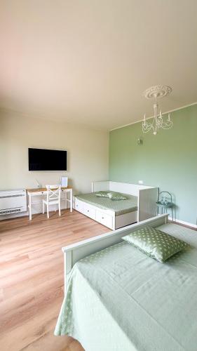 a room with two beds and a flat screen tv at La Dimora Di Roncajette Alloggi e Trattoria 