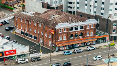an overhead view of a city with cars parked on a street at Strathfield Hotel in Sydney