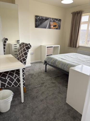 a bedroom with a bed and a desk and a chair at 4 bed Laurel Drive Newport TF10 in Newport
