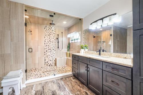 a bathroom with a shower and a sink and a showerspective at Elegant 4BR Pool Sanctuary - Ideal for Work or Play! in Palm Bay