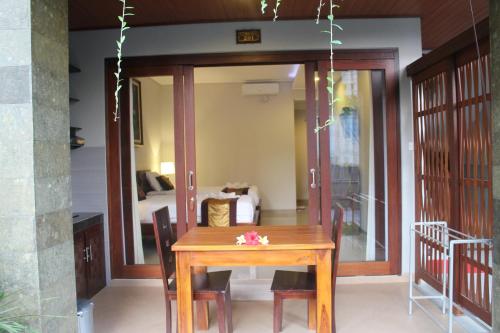 a wooden table and chairs in a room at Betutu Bali Villas in Ubud