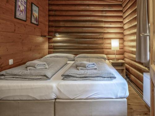two beds in a room with wooden walls at Yosi im Brixental in Wörgler Boden