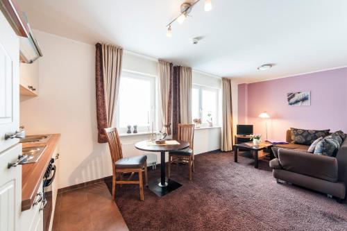a living room with a couch and a table at Hotel Fauna in Breiholz