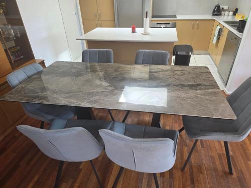 a marble table and chairs in a kitchen at Hide out in Gungahlin
