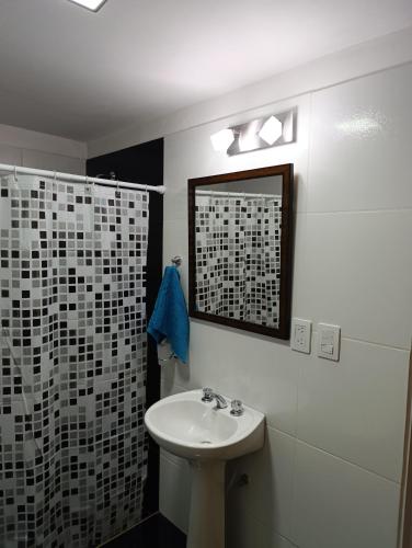 a bathroom with a sink and a shower at Sinaí Apart in Santa Rosa de Calamuchita