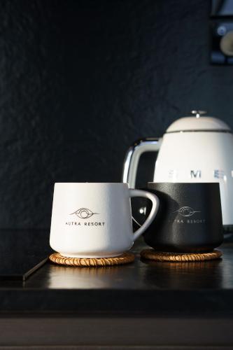 two coffee cups sitting on a counter next to a toaster at AUTRA Resort Lyndoch in Lyndoch