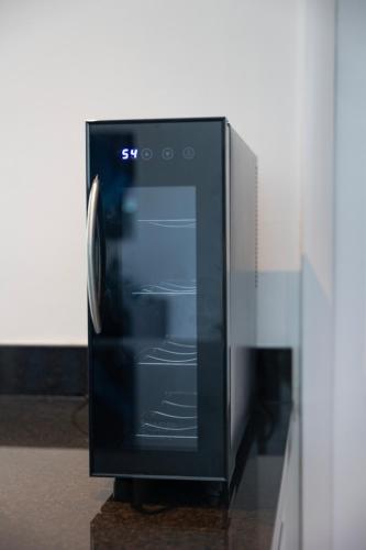 a black microwave oven sitting on top of a counter at GroveO5 10 minutes from Miami Beach in Miami
