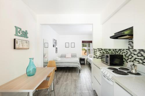 a kitchen with a table and a dining room at The Oasis in Miami