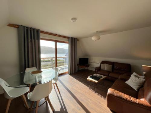 a living room with a glass table and a couch at Glenlude - Uk50493 in Kylestrome
