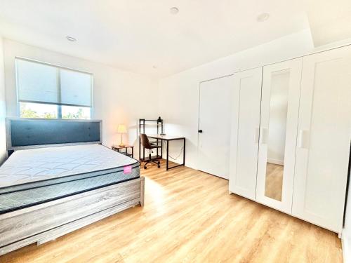 a bedroom with a bed and a desk at 1433 Nespace in Los Angeles