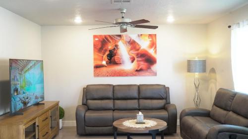 a living room with a couch and a ceiling fan at Red Rock Retreat Your Home Away From Home in Kanab