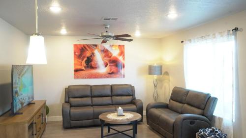 a living room with a couch and a ceiling fan at Red Rock Retreat Your Home Away From Home in Kanab