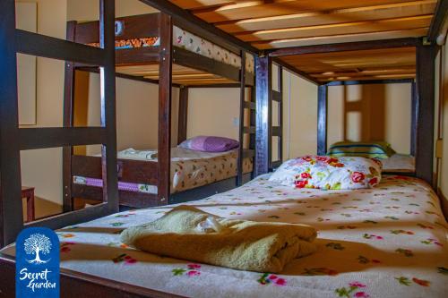 a bedroom with two bunk beds with aoodoo at Secret Garden in Cusco