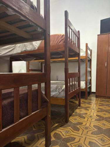 a room with three bunk beds in a room at Hostal Yatasto in Salta