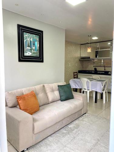 a living room with a couch and a kitchen at Apartment in Ananindeua in Ananindeua