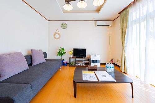 a living room with a couch and a coffee table at Extreme in Sapporo