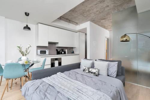 a bedroom with a bed and a dining room at Urban Oasis Condo with Cafe & Bar at Your Doorstep in Toronto