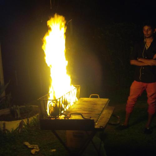 a man standing in front of a fire grill at Yala Dream Park in Yala