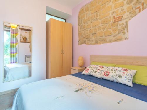 En eller flere senge i et værelse på Alla Corte del Re Dimora Storica