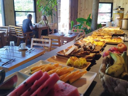 a table filled with lots of different types of food at Bosque Las Delfinas in Punta Colorada