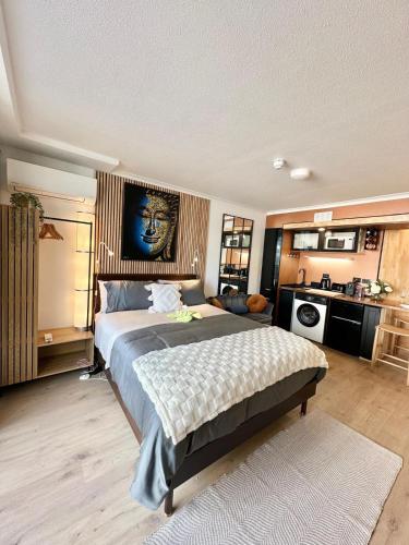 a bedroom with a large bed and a kitchen at West End Central Apartments in Brisbane