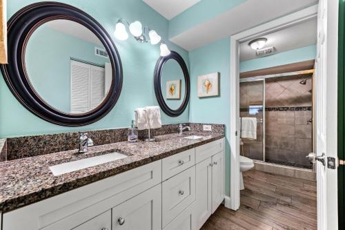 a bathroom with two sinks and a shower at Sand Dollar Suite - 632A in Siesta Key