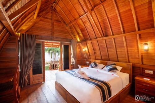 Ένα ή περισσότερα κρεβάτια σε δωμάτιο στο The Gili Menjangan