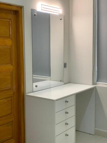 a white cabinet with a mirror on top of it at Regus Jaffna in Jaffna
