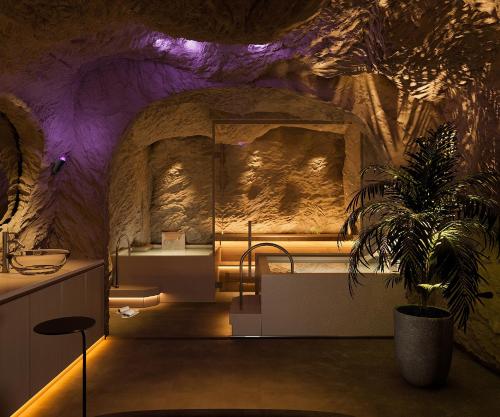 a room with a bed in a cave at Kin Hotel Onsen Edition in Ho Chi Minh City
