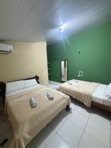 Ένα ή περισσότερα κρεβάτια σε δωμάτιο στο Pousada pipa meu amor