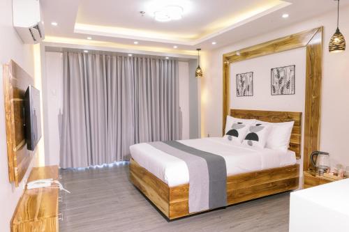 a hotel room with a bed and a television at Emavel Beach Resort in Balaoan