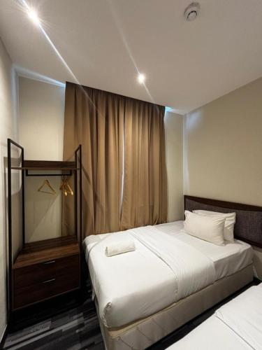 a bedroom with a white bed and a mirror at iBilik Hotel - KLIA 1 KLIA 2, Sepang in Sepang