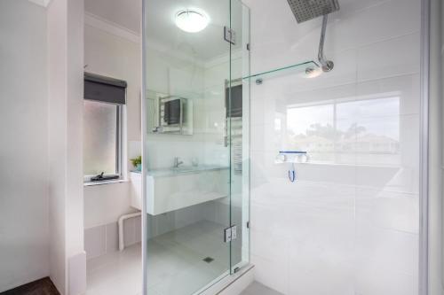 a shower with a glass door in a bathroom at The Whitehouse - South Yunderup in South Yunderup