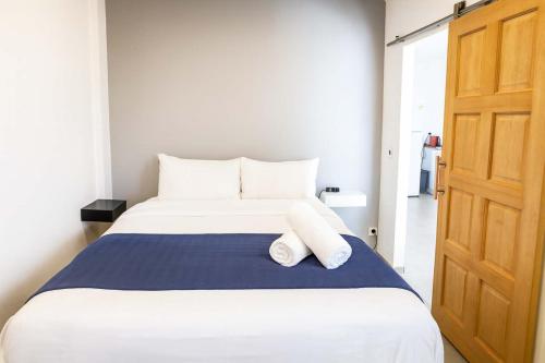 a bedroom with a bed with two pillows on it at BBL Ferry Lodge in Papeete