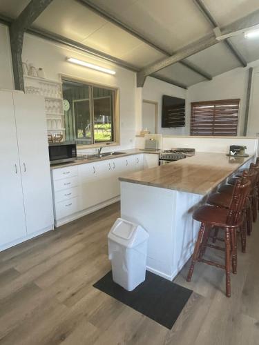a kitchen with a large island with a counter top at Orchid Oasis Orchid Beach KGari Fraser Island in K'gari Island (Fraser Island)