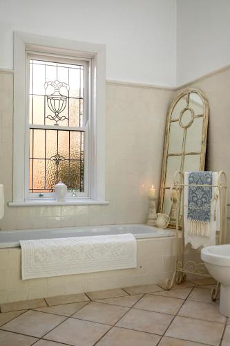 a bathroom with a tub and a window and a sink at 23onWindsor in Hahndorf