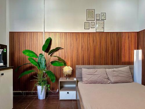 a bedroom with a bed and a wooden wall at Taibo-house in Ho Chi Minh City