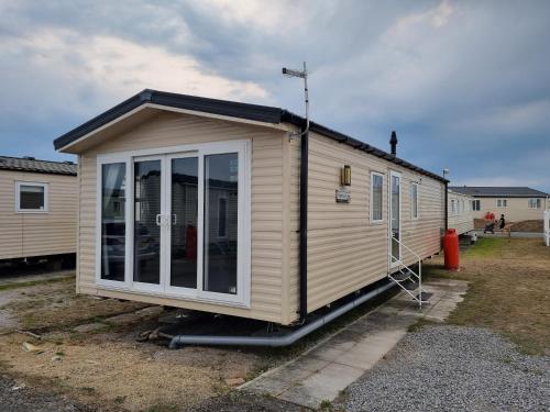 a tiny house is parked in a yard at Newton Beach retreat in Porthcawl
