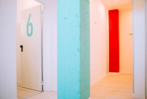 a room with white walls and a blue wall at Palma Port Hostel - Albergue Juvenil in Palma de Mallorca