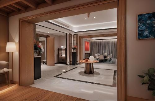 a lobby with a table and a living room at Arvesto Lux Jakarta in Jakarta