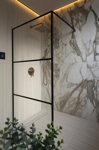 a shower with a glass door in a bathroom at 2 BEDS Free Parking Right Where You Want to Be in Pittsburgh