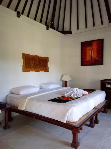 a bedroom with two beds in a room at The Chapel Alam Sari Ubud in Ubud