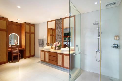 a bathroom with a shower and a sink at Villa J Deluxe in Canggu