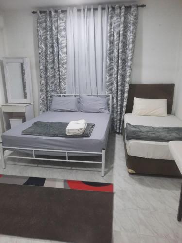 Postel nebo postele na pokoji v ubytování Ezy Nano Homestay