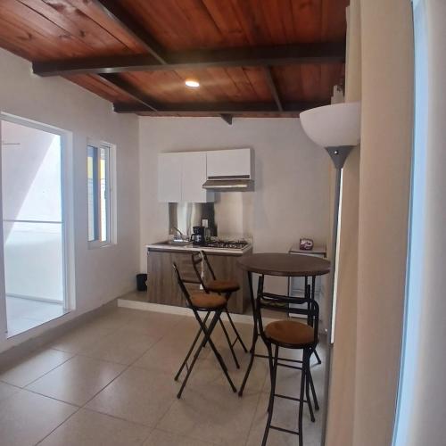 a kitchen with a table and chairs in a room at The Magic in Oaxaca City